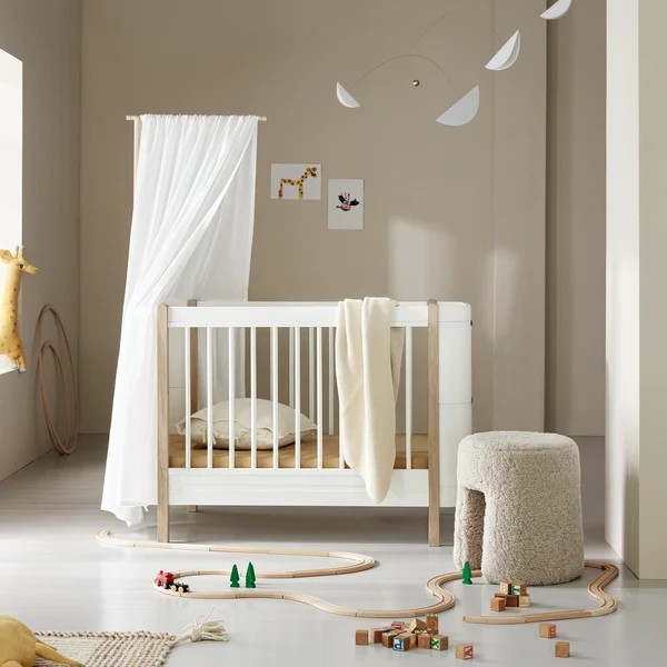 Skandinavisches Babybett mit flexibler Umbaumöglichkeit. (Szene)